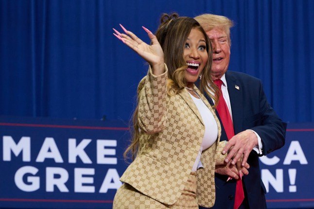 President Donald Trump helps Nicki Minaj to the stage during a campaign rally at McMorran Place Sports and Entertainment Center, Sunday, Oct. 25, 2026, in Port Huron, Mich. (AP Photo/Julia Demaree Nikhinson)